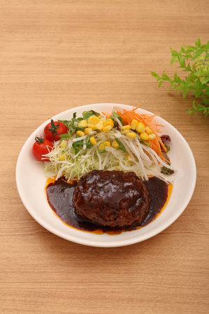 Hamburger steak and cherry tomato saladの写真素材