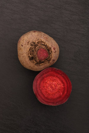 Fresh beetroot on black slate background. Top view with copy space