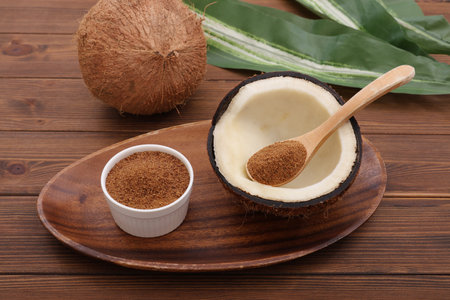 Coconut sugar in a bowl on wooden backgroundの写真素材