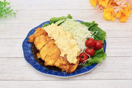 Crispy fried chicken breast with mayonnaise sauce and saladの写真素材