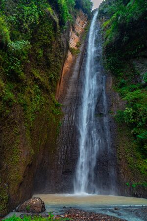 Sidoharjo Waterfall Located in Middle of Forest in Menoreh Highland, Indonesiaの写真素材