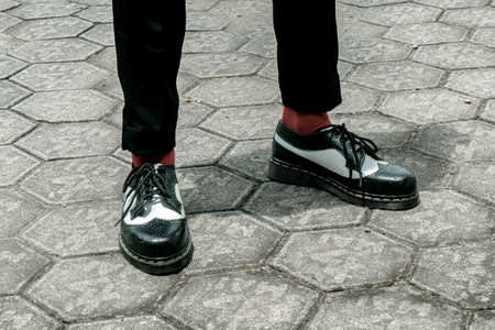 Close-up of two tone black and white men's genuine leather shoes brogues wingtips handmade by a home shoe craftsmanの写真素材