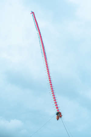 Dragon kites that fly in the sky of Parangtritis beach, Yogyakarta, Indonesia when the evening until the sun goes down, becoming an interesting spectacle for visiting tourists.の写真素材