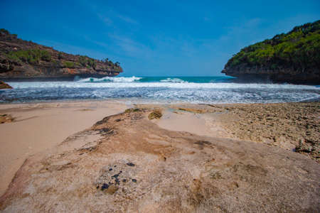 The beaches around Gunung Kidul, Indonesia are a favorite destination for tourists because of the beauty of the beaches due to the waves, white sand and coral scattered in every coの写真素材