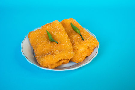 One of the traditional snacks in Indonesia, golden rissole filled with mayonnaise with green chilies on topの写真素材