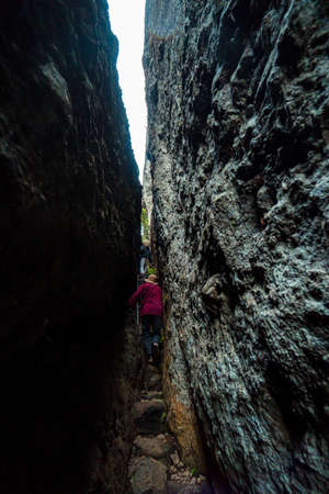 One of the hiking routes to the top of the ancient volcano Nglanggeran, Indonesia, there are 2 large rocks with a small path in the middleの写真素材