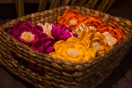 Close-up of colorful flowers in a rattan box to decorate the room. The interior of a boho style house consists of handcrafted flowers of various colorsの写真素材