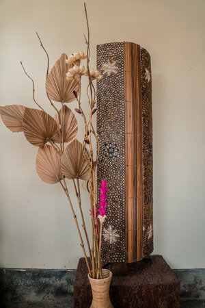 Boho style living room interior with elegant accessories in the form of dried flowers and plants such as dried reed bouquets to decorate the room with a white wall background.の写真素材