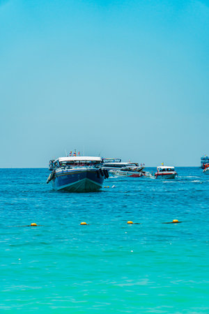 Speed boats and traditional boats in every corner of the sea in Krabi, Thailand. The vast Andaman...