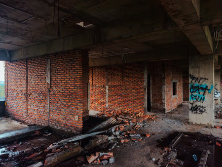The inside of a former multi-storey building that was almost destroyed. An abandoned building with lots of puddles of rainwater, dirty and messyの写真素材