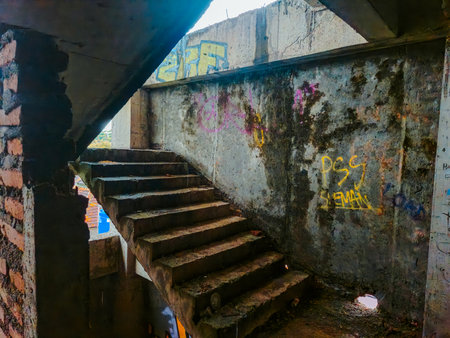 The inside of a former multi-storey building that was almost destroyed. An abandoned building with lots of puddles of rainwater, dirty and messyの写真素材