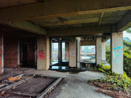 The inside of a former multi-storey building that was almost destroyed. An abandoned building with lots of puddles of rainwater, dirty and messyの写真素材
