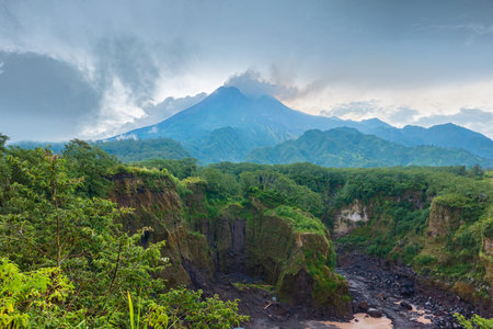 Panorama of Mount Merapi from a close distance with rows of clouds around it in the afternoon....