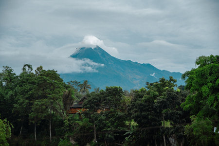 Aerial view of the mountain in the morning with a panorama of dense forest in front. Aerial photography of the panoramic beauty of Mount Merapi from a distance.の写真素材
