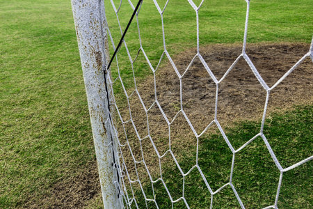 Soccer goal in a field in a beautiful countryside in the morning. Detail of a soccer goal that is slightly rusty but still usableの写真素材