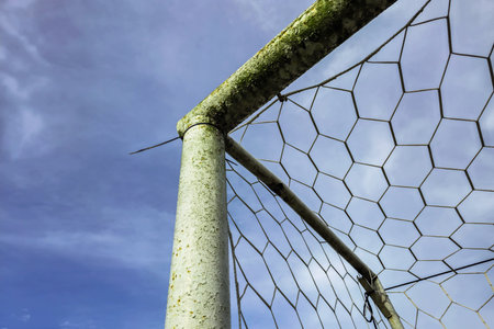 Soccer goal in a field in a beautiful countryside in the morning. Detail of a soccer goal that is slightly rusty but still usableの写真素材