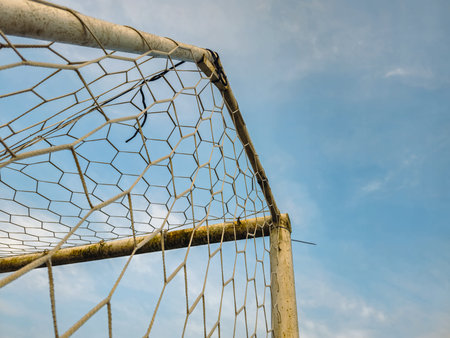Soccer goal in a field in a beautiful countryside in the morning. Detail of a soccer goal that is...