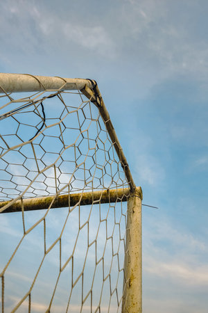 Soccer goal in a field in the morning. Detail of a soccer goal that is slightly rusty but still usableの写真素材