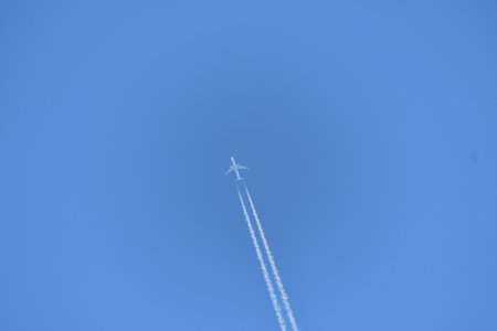 A jet plane flying in the blue sky.
