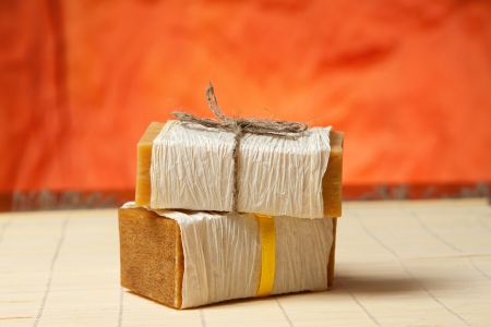 natural soap tied with a ribbon on a bamboo matの写真素材