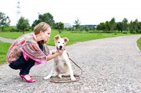 sexy woman playing with her golden retriever puppyの写真素材
