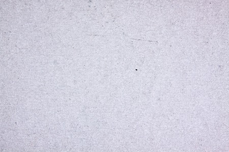 grey cardboard sheet closeup, abstract background for designの写真素材