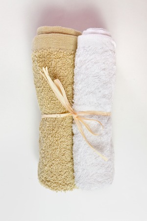 beige and white face towel, tied with twineの写真素材
