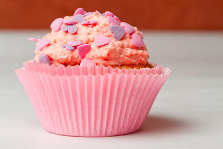 strawberry cupcake with icing sprinkles and whipped creamの写真素材