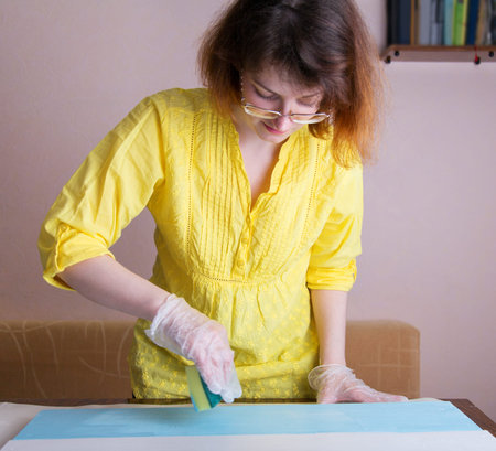 creative work on wood, a woman works in her workshop