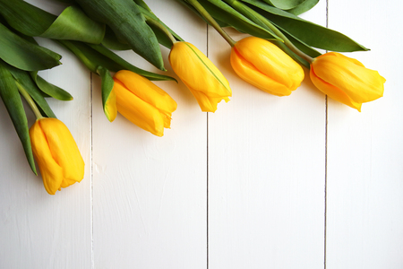 Beautiful yellow tulips on wooden background, copyspaceの写真素材