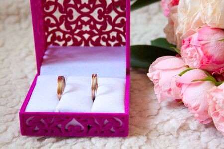 two wedding bouquet and rings in the box on a luxury sofaの写真素材