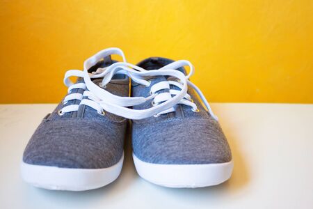 New sneakers on a yellow background. Youth urban casual shoesの写真素材