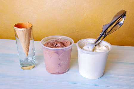 Ice cream set - cones, vanilla and chocolate ice cream, spoon for making ball.の写真素材