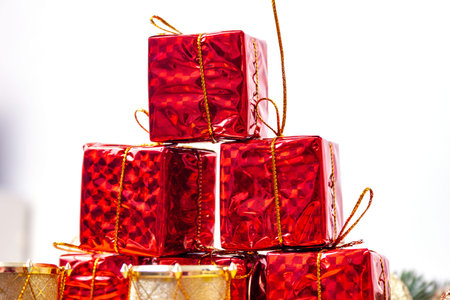 Small red boxes of gifts in a pile on the table - New Years decorの写真素材