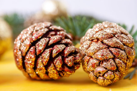 Pine cones covered with sparkles on the tableの写真素材