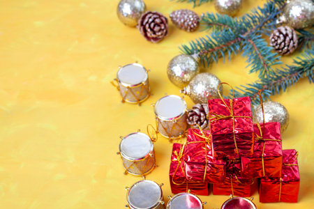 Small gift boxes in a stack on the table, drums and golden ballsの写真素材