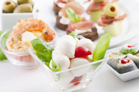 Antipasto with caprese, canapes and seafoodの写真素材