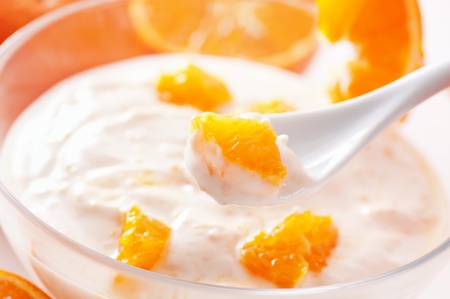 Orange yoghurt on the spoonの写真素材