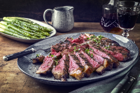 Wagyu T-Bone Steak with Green Asparagus on Plateの写真素材