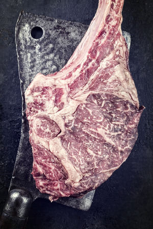 Wagyu Tomahawk Steak on old Kitchen Cleaverの写真素材