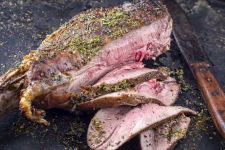Barbecue Haunch of Venison on old metal sheetの写真素材