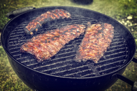 Barbecue Pork Spare ribs as close-up on a kettle grillの写真素材