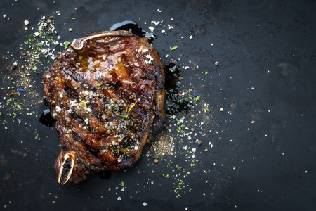 Barbecue dry aged wagyu cutlet as top view on a board with copy spaceの写真素材
