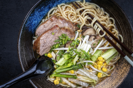 Traditional Japanese shoyu ramen with chashu as top view in a bowl with chopsticksの写真素材