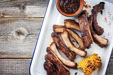 Barbecue spare ribs St Louis cut with hot honey chili marinade as top view in a skilletの写真素材