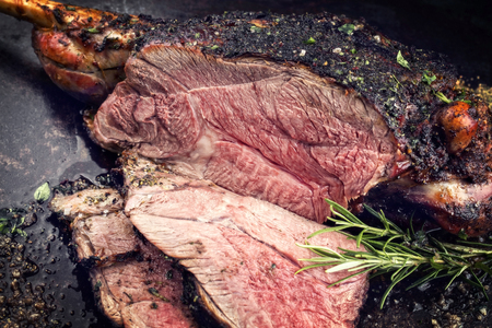 Traditional barbecue leg of lamb with spice and herbの写真素材