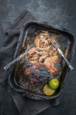 Traditional barbecue pulled pork piece of Bosten butt torn to bits as close-up in an old skilletの写真素材