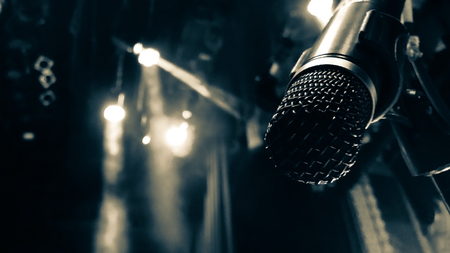 open microphone on the background of the concert matte lightingの写真素材