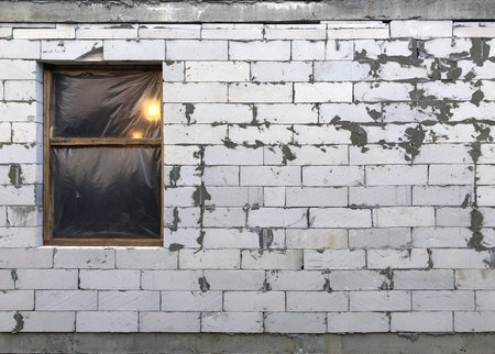 The light in the window during the construction of the house. Elements of production.