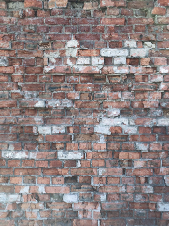 A wall with a torn brick of old age for use as a background or screen saver.の写真素材